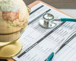 Patient's healthcare record clip pad with doctor's stethoscope on work table